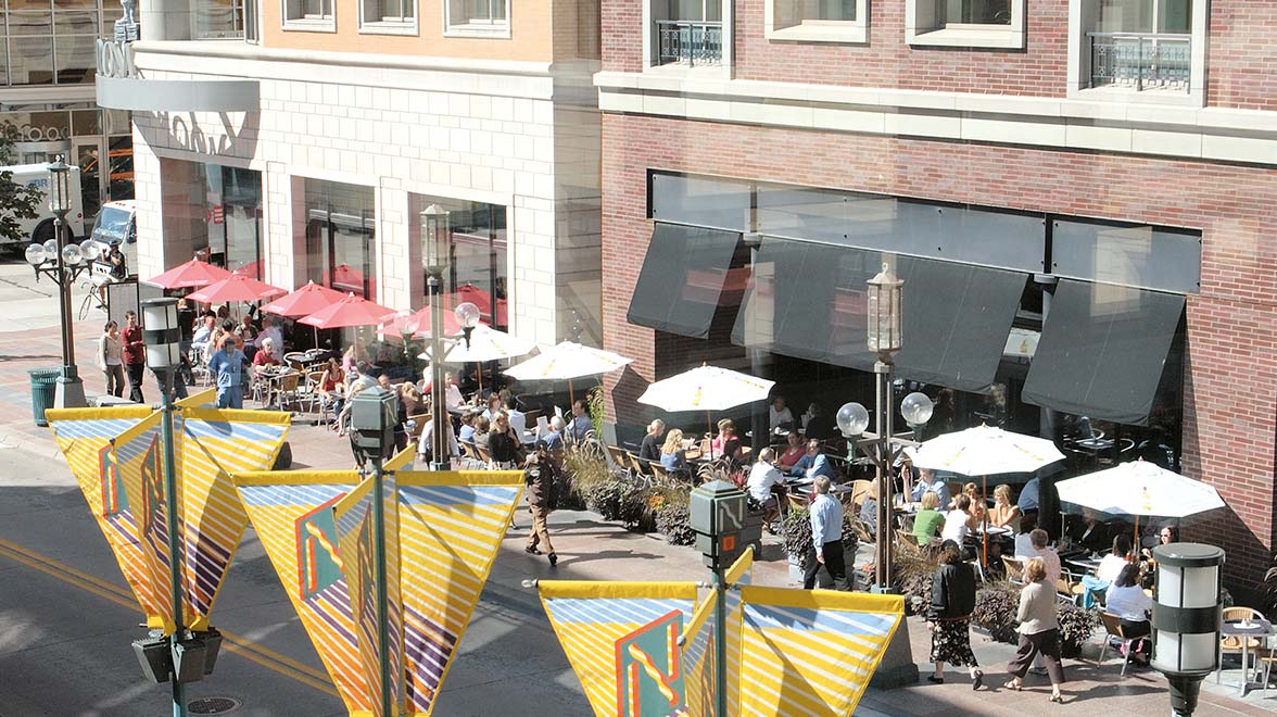 Vistors are spending time at the coffee shops and restaurants in front of the office building in Central Minneapolis